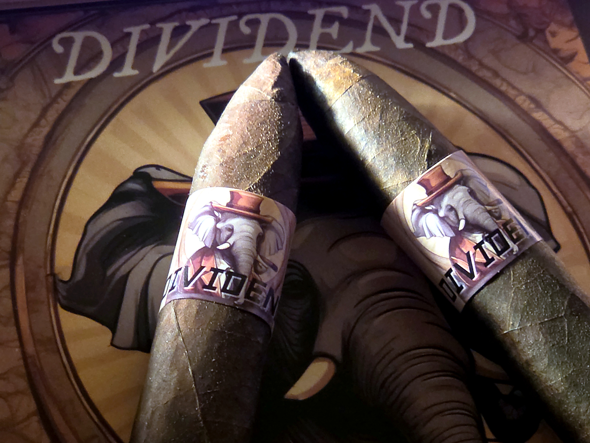 Two Dividend cigars on a table