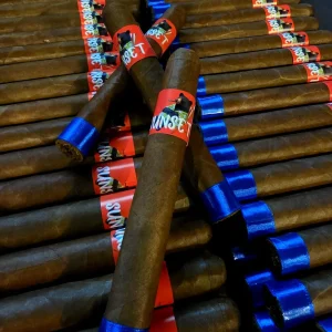 Rows of Sunset cigars with red bear bands and blue foot ribbons, with several cigars arranged diagonally on top.