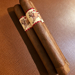 Three cigars on warm leather